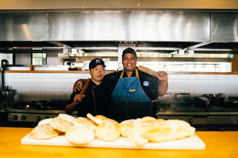 Mod Pizza team members smiling and working together in a welcoming environment